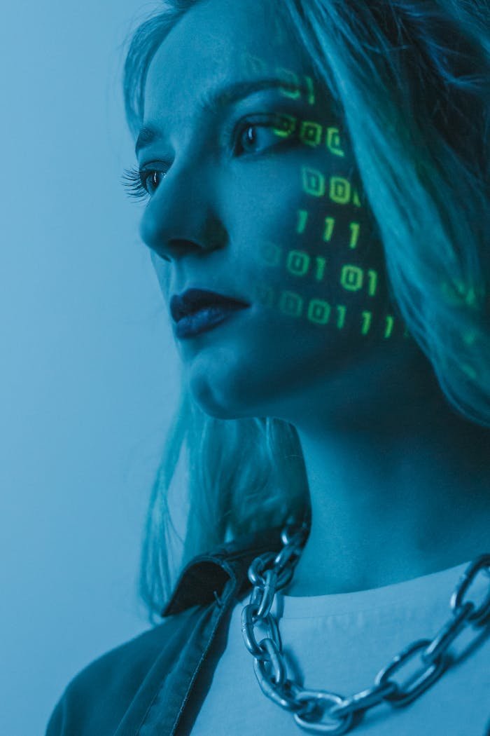 Tech-inspired portrait of a woman with digital code projected on her face, symbolizing cybersecurity.